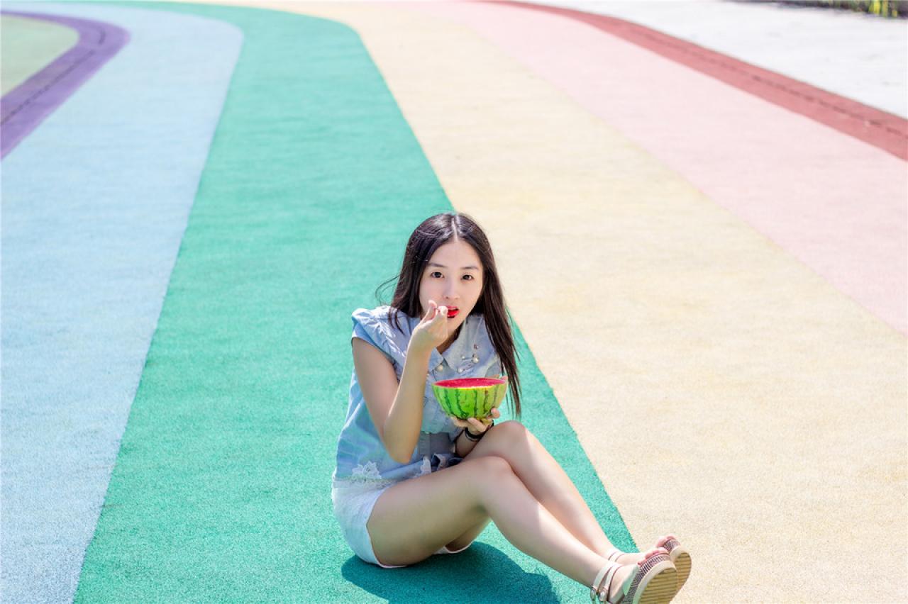陈婕坐在跑道上，正吃着西瓜