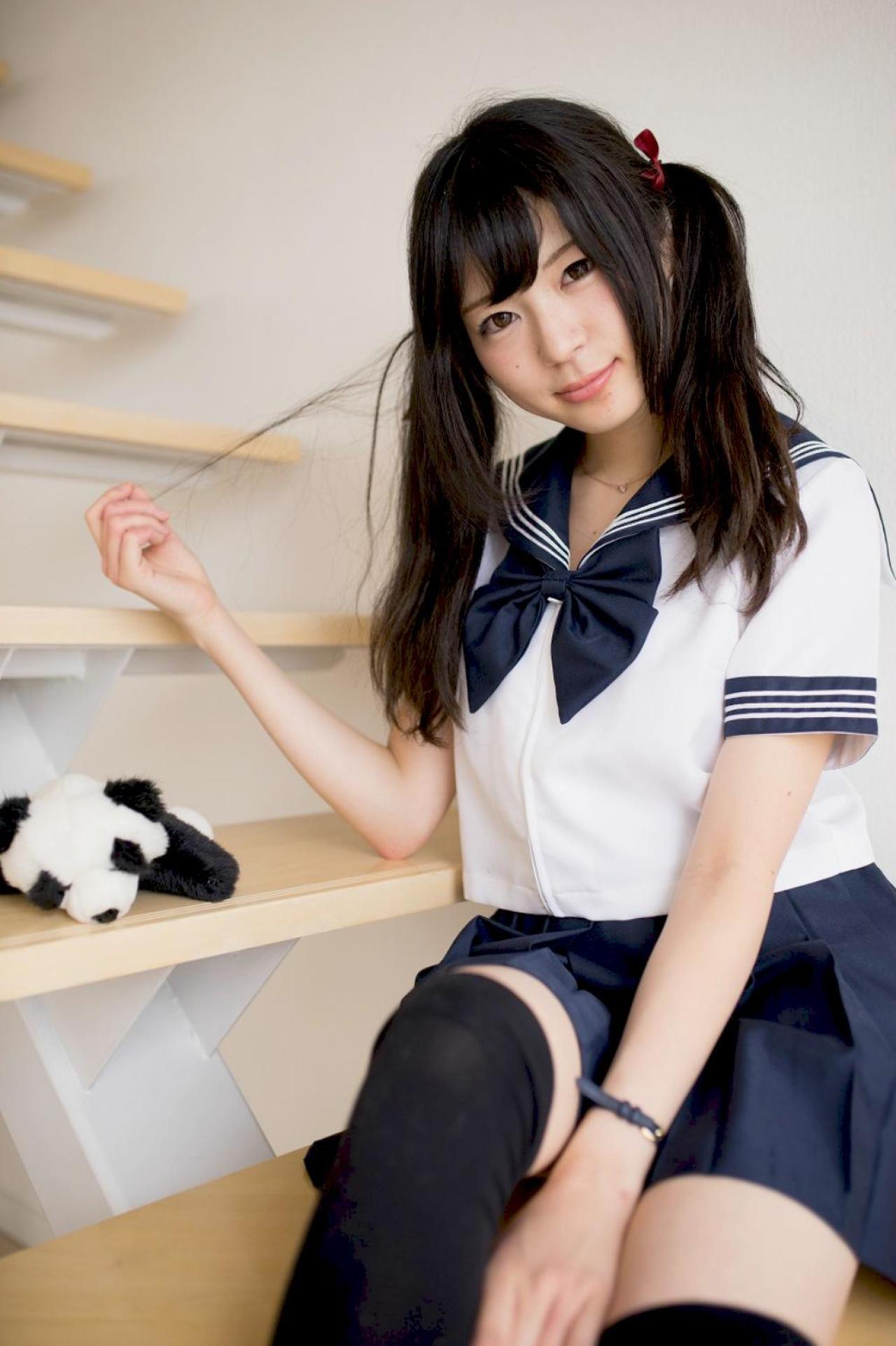 未凛坐在台阶上，右手拉起发丝，身旁放着熊猫玩偶